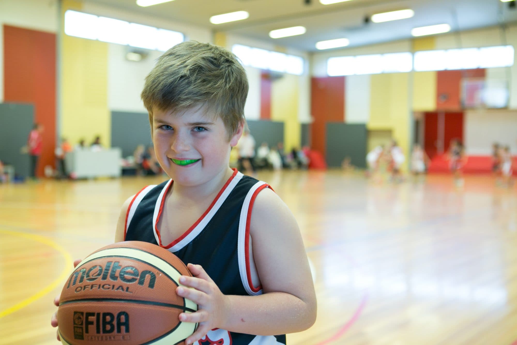 A young basketball player wearing a mouthguard